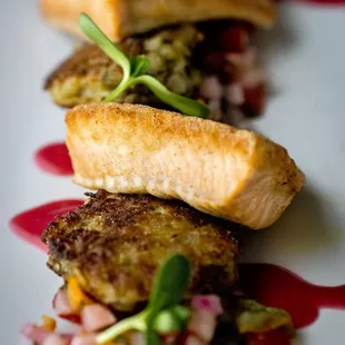 three pieces of fish on a white plate