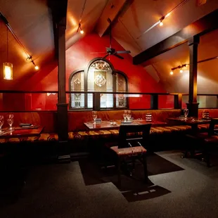 the interior of a restaurant with red walls