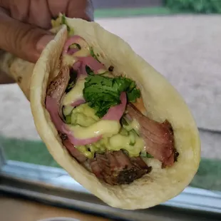 The Bark Taco on flour: smoked brisket, spicy guac, pickled onions, cilantro. Yum!