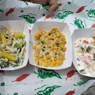 Jalapeño pineapple slaw, jalapeño creamed corn, and white potato salad with curtido.