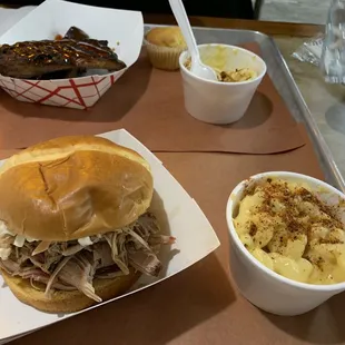 The pulled pork sandwich with coleslaw on top, Mac and cheese, and the ribs.