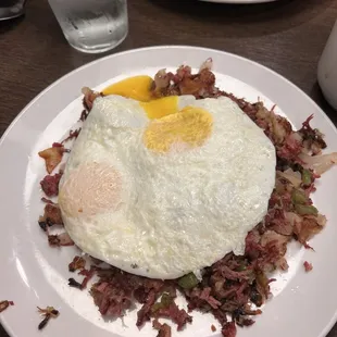a plate of eggs and hash browns