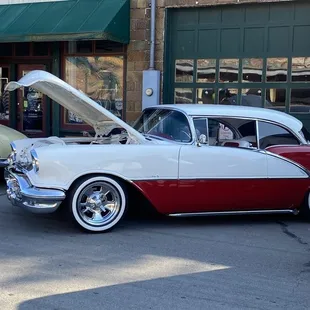 a man looking at a classic car