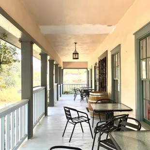 a porch with tables and chairs