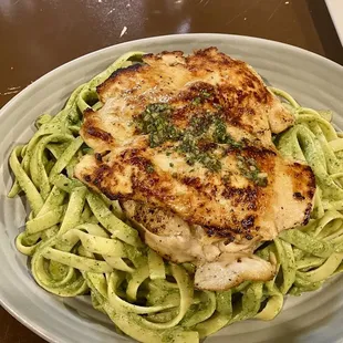 Grilled chicken with Peruvian spices, over a bed of pesto Fettuccine