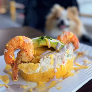 Causa de Pollo y Camaron: Mashed potatoes, avocado, egg, chicken, shrimp, mayo, green peas | $13