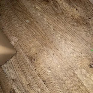 Broken glass and trash on floor not swept well