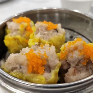 three dumplings in a metal container