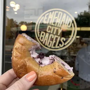 a hand holding a doughnut