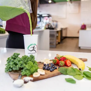 a woman pouring a smoothie