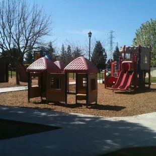 Plenty of playground equipment for kids, some with bark, some with rubber flooring