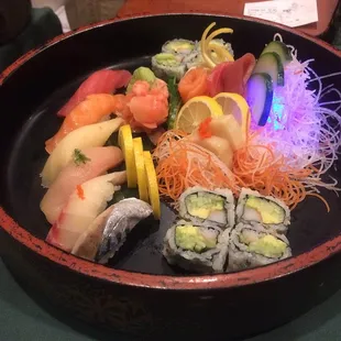 a bowl of sushi and vegetables