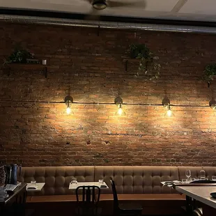 a restaurant with a brick wall