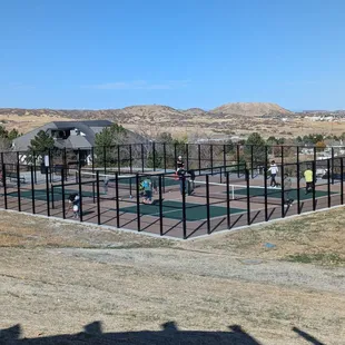 Four pickleball courts that look like they're facing north south so you're not staring directly into the Sun.
