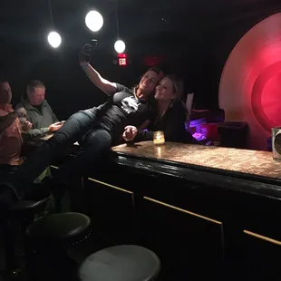 a group of people sitting at a bar