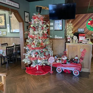 a christmas tree and a red wagon