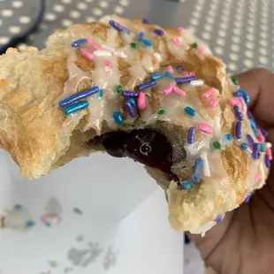 a half eaten pastry with sprinkles