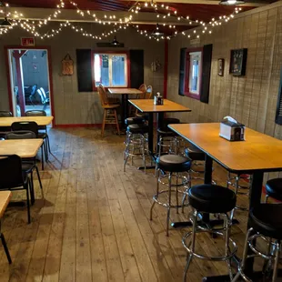 a dining room with tables and stools