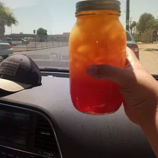 a person holding a jar of food