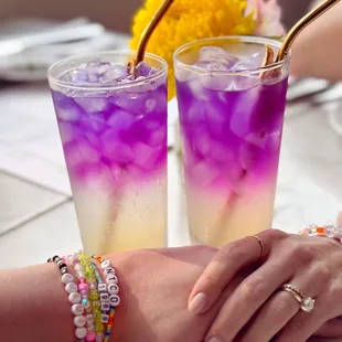 two glasses of purple and yellow drink