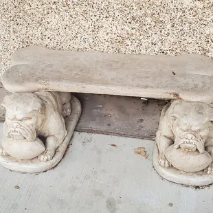 a stone bench on the sidewalk