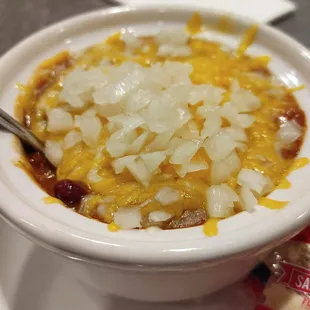 a bowl of chili and cheese