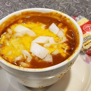 a bowl of soup with ice cubes