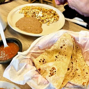 a plate of quesadillas and a bowl of salsa