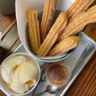 Churros with vanilla ice cream and caramel sauce.