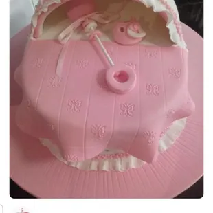 a pink cake with an umbrella