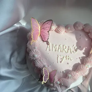 a heart shaped cake with butterflies