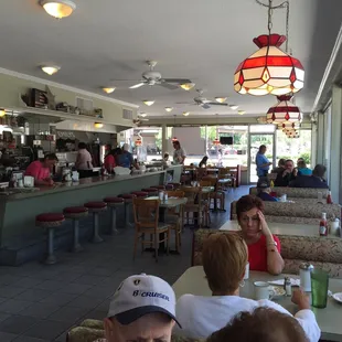Nice booths along the sidewalk hedges with a counter by the kitchen