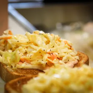 a closeup of a sandwich with coleslaw