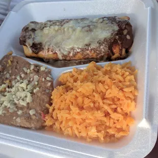 Chimichang with mole sauce, beans and rice.