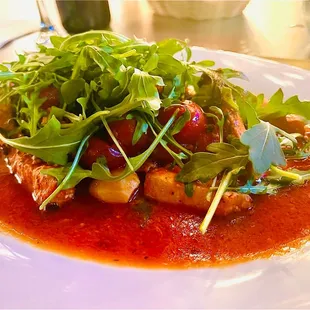 Swordfish in a sugo with fresh tomatoes, olives and fresh arugula. Absolutely one of the best dishes!