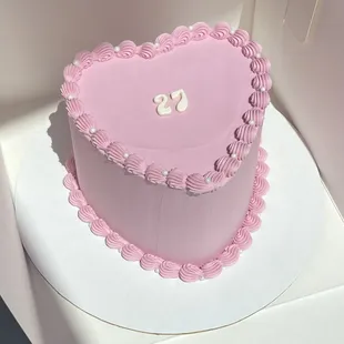 a pink heart shaped cake