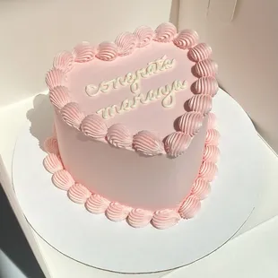 a pink heart shaped cake