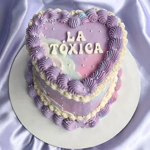 a purple heart shaped cake with a name on it