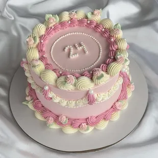 a pink and white cake on a white plate