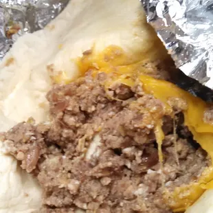 a hand holding a burrito