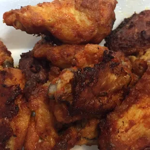 Wings are slightly crispy and moist, with hotness similar to medium level.