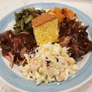 Brisket and pulled pork with yam, collard greens, cornbread, and coleslaw. IG: @take.a.bite.with.me