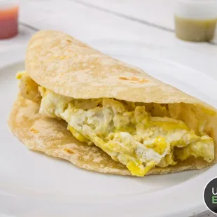 a breakfast burrito on a white plate