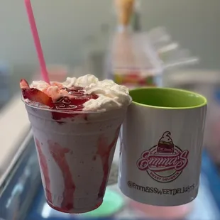 a cup of ice cream and a strawberry milkshake