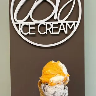 a hand holding an ice cream cone