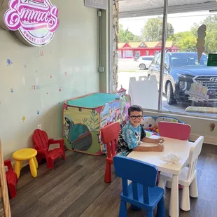 a little boy sitting at a table