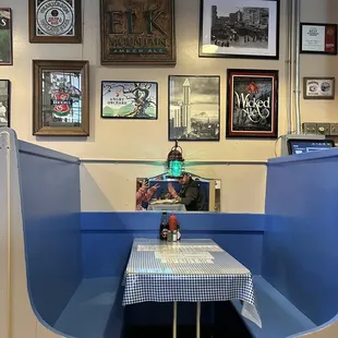 a booth with a checkered tablecloth