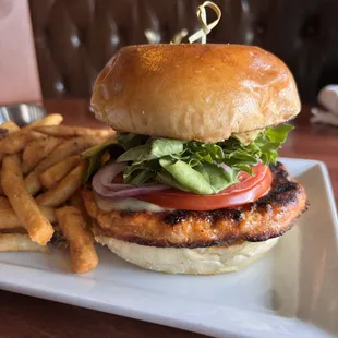 Salmon Burger (sushi grade salmon) with pepper jack cheese, leafy greens, tomato, red onions, avocado, sweet sesame sauce, on a toasted bun!