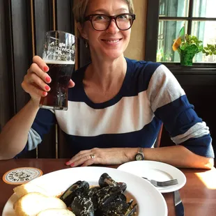 a woman holding a glass of beer