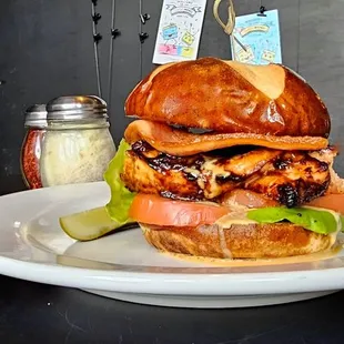 Salmon BLT | miso marinated salmon, bacon, lettuce, tomato, pretzel bun.